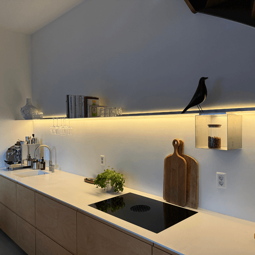 Wandplank in Raw Aluminum met verlichting onder en rondom warm licht Strackk bij klant in Ijburg Amsterdam 1080 x 1080 pxl