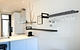 Black kitchen shelves from Strackk with wineglass rack and book supports in white kitchen