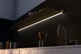 Wall shelf with lighting underneath. Ideal lighting above kitchen countertop. Floating wall shelf in gold. From Strackk. Bottom view